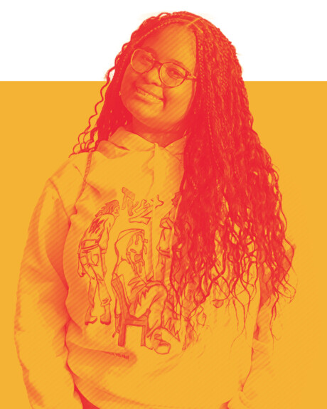 Undergraduate student Makiyah Smith '28 tilts her head and wears an artsy modern-designed sweatshirt.