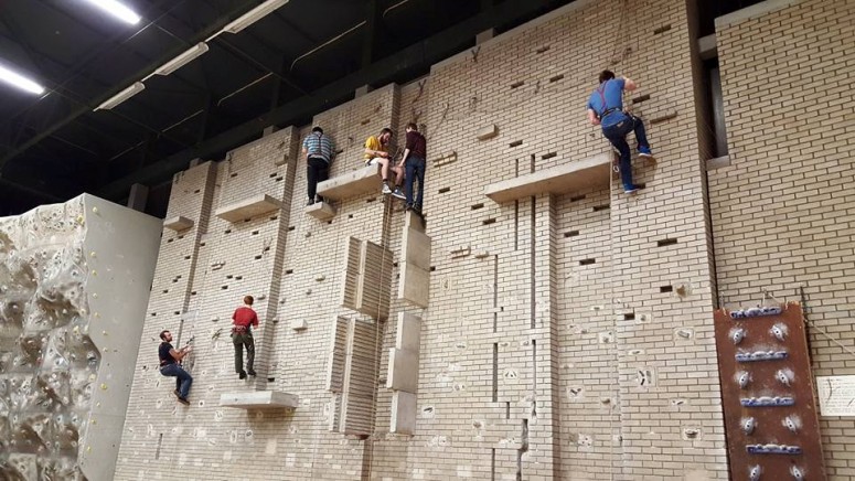 Several people rock climbing a wall.