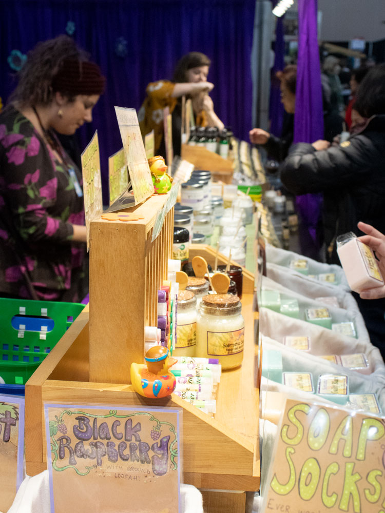 A table selling handmade soaps and comestic jars.