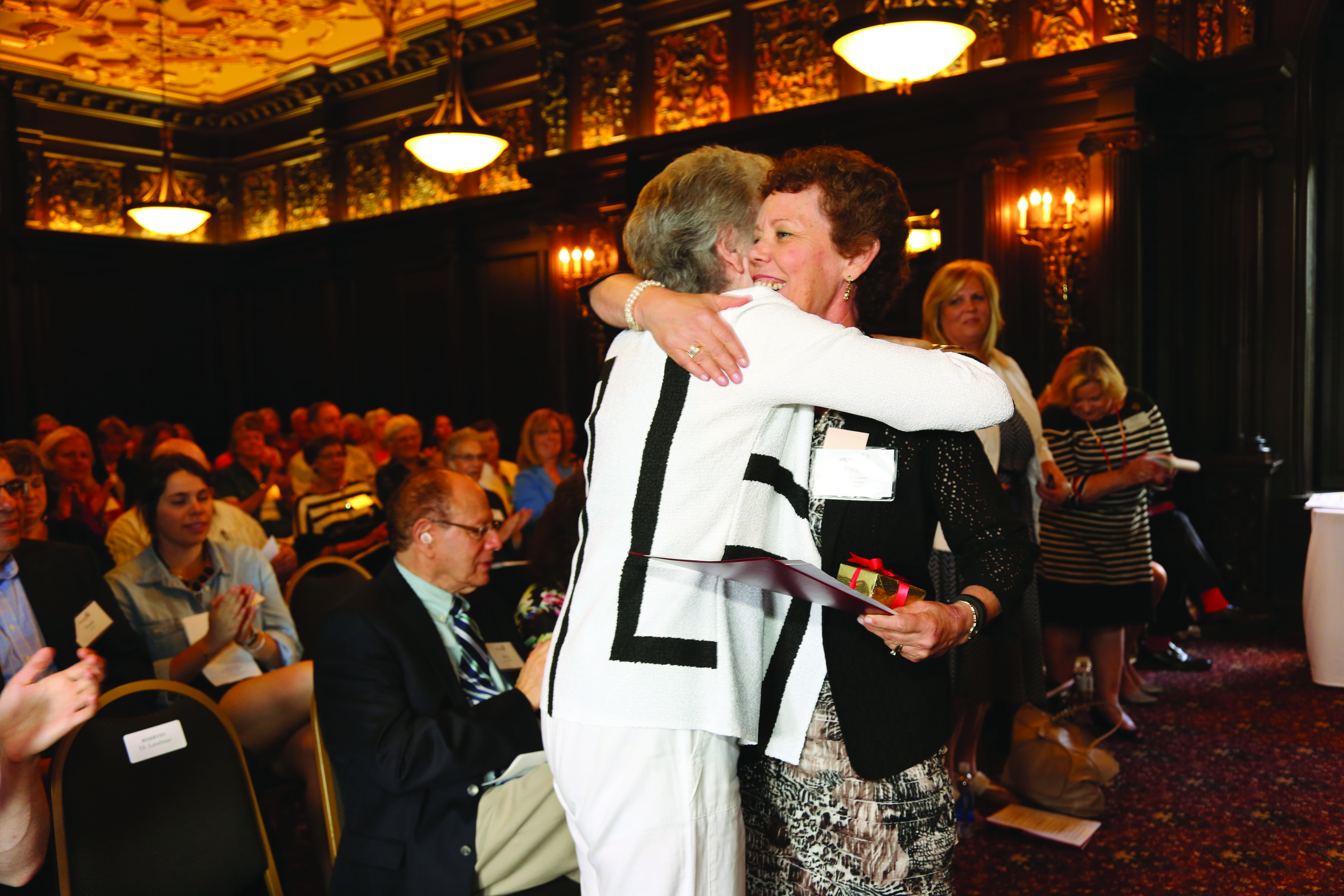 Emily Perkins Capella hugging President Emerita Bette Landman during award ceremony.