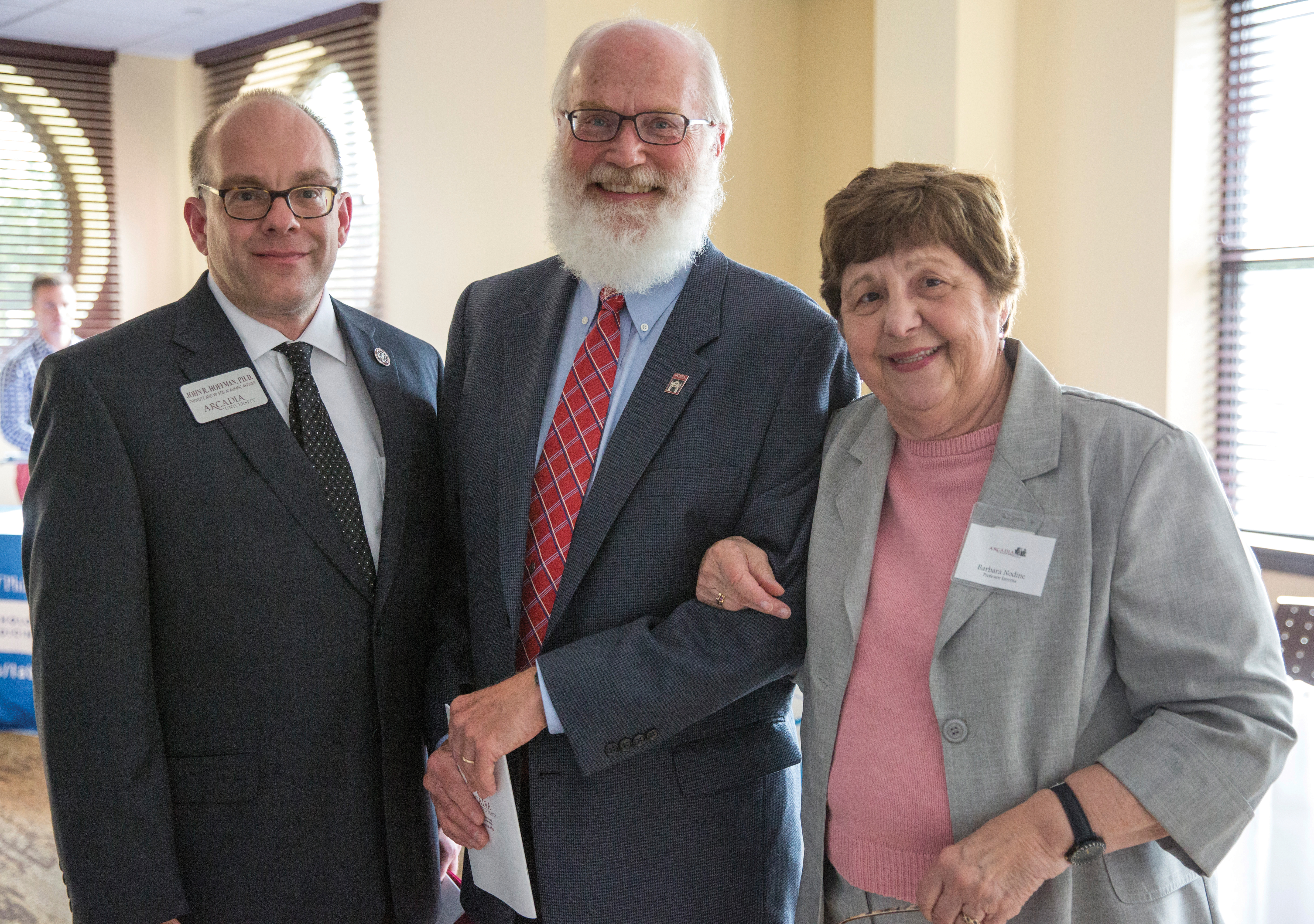 John Hoffman posing with two Senior Alumni students.