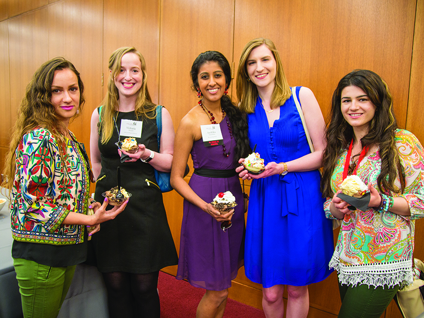 Five woman holding ice cream sundaes in their hands celebrating Alumni Weekend.