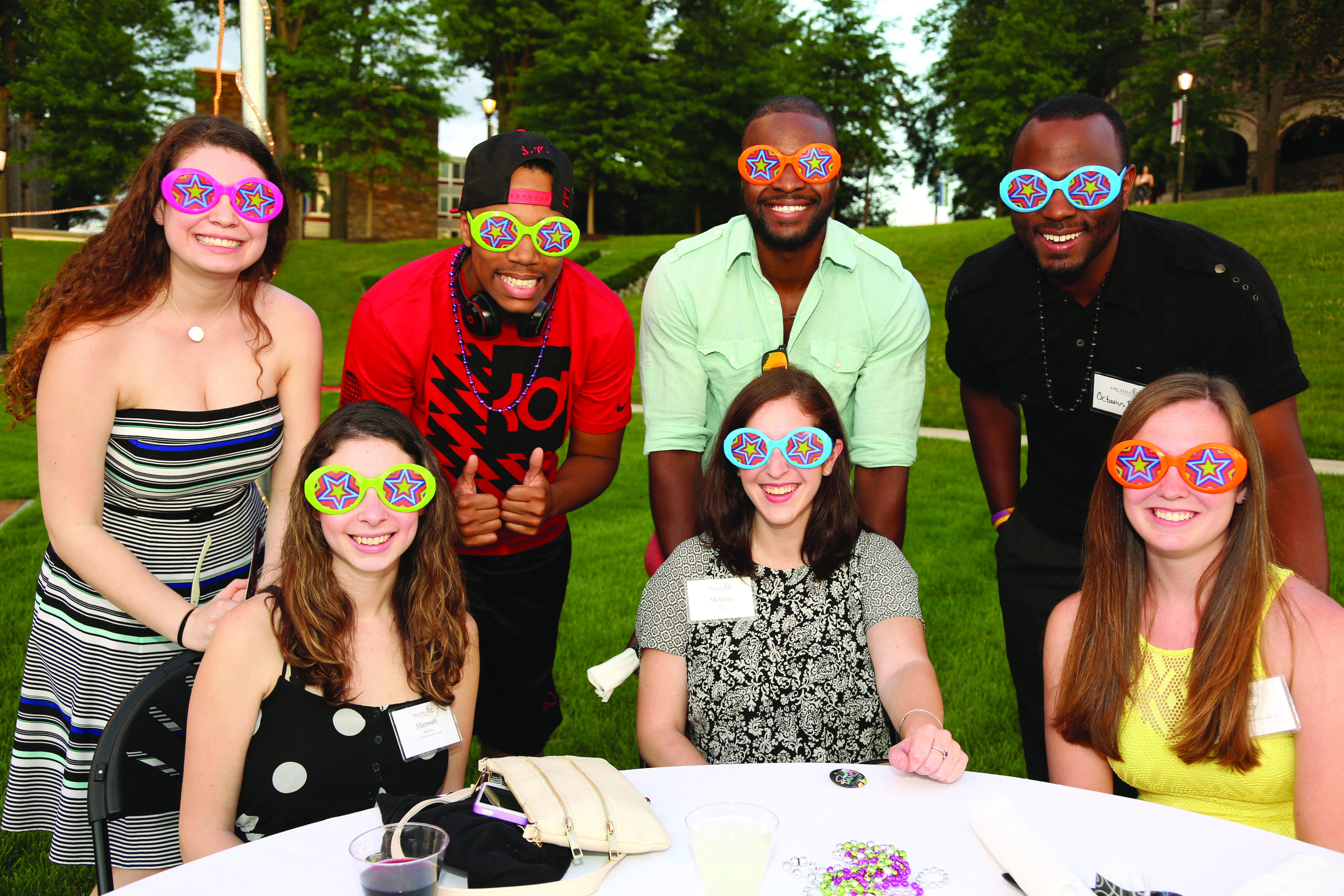 Group of alumni wearing funny sunglasses.