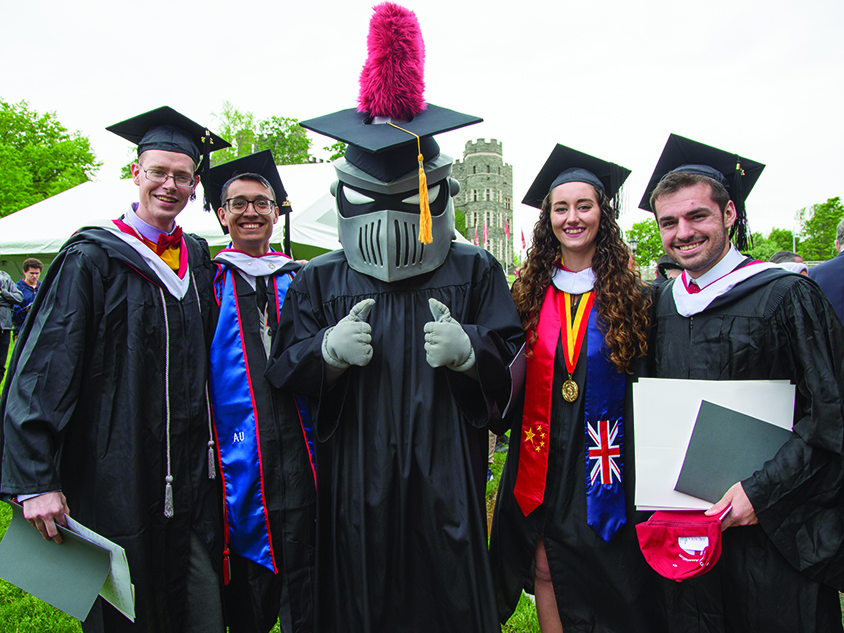 Graduating students posing with Archie, Arcadia's mascot.