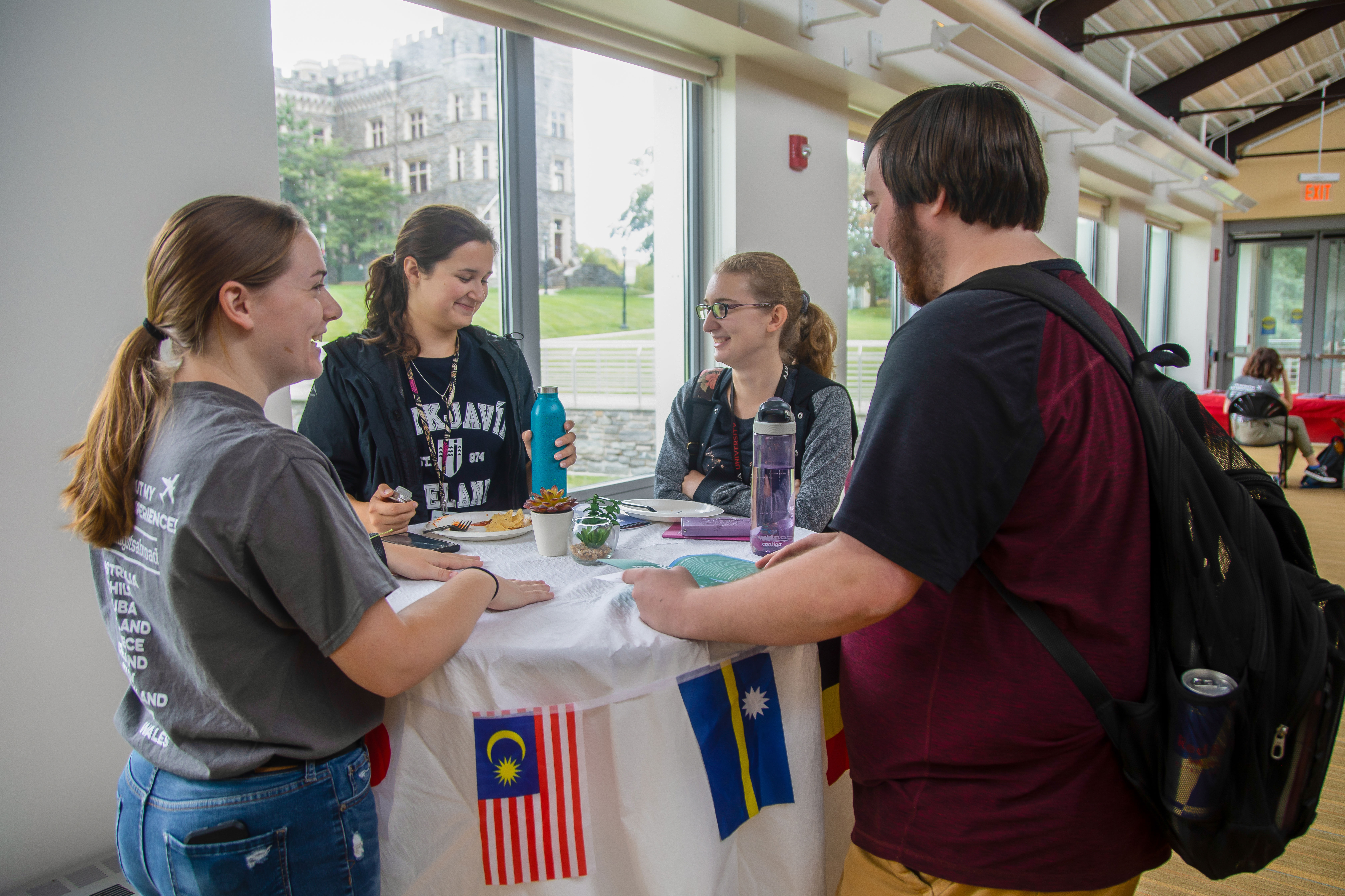 Four people around a talking to each at the Study Abroad Fair.