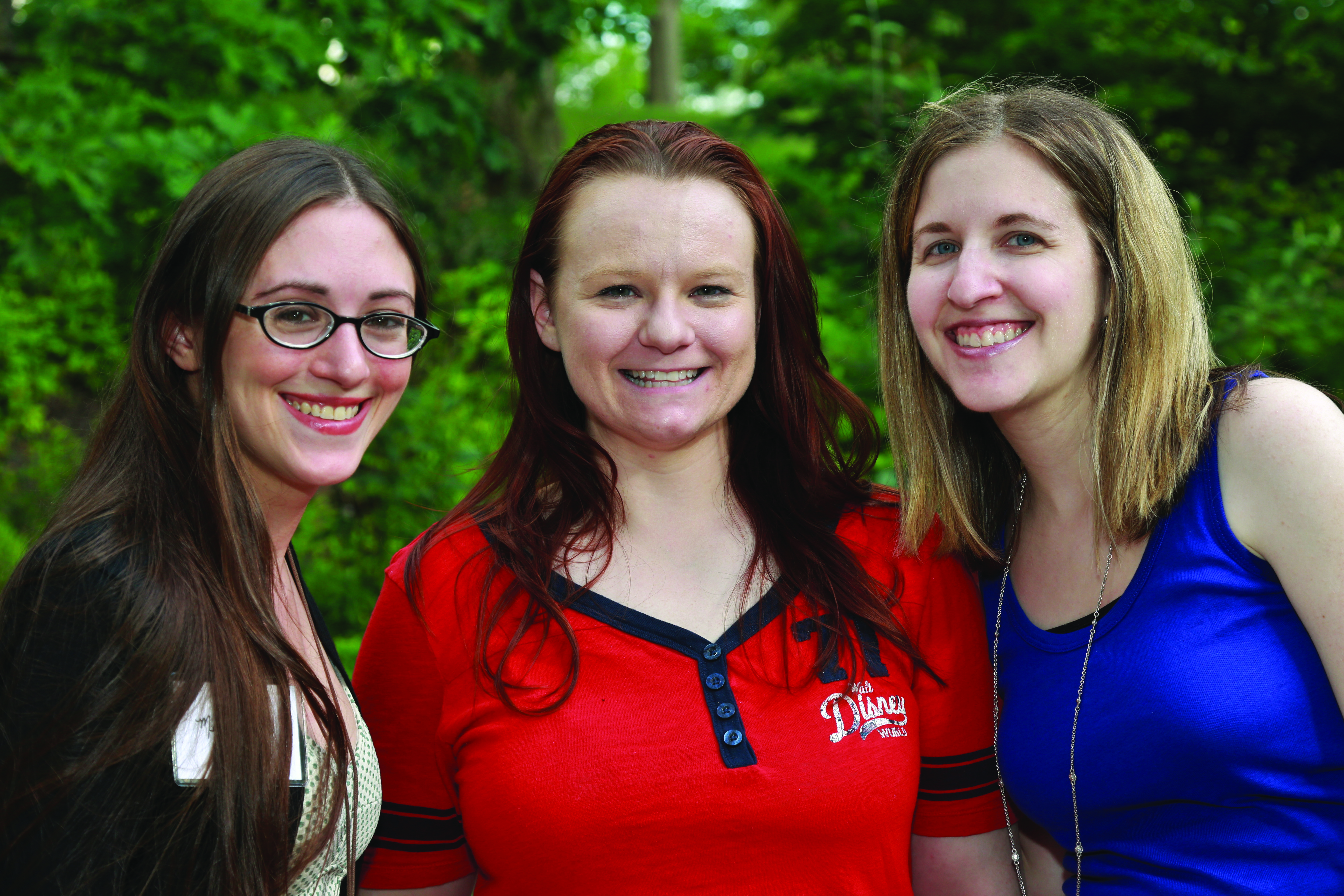 Three alumni students posing together.
