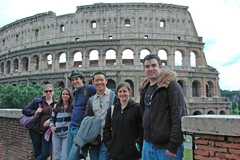Arcadia study abroad students stand in front of ruins