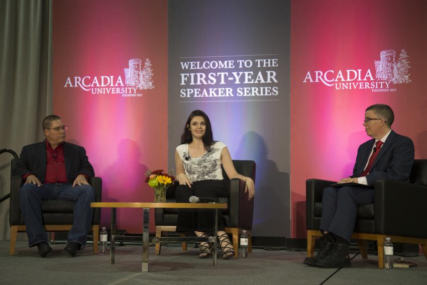 Nicoles Maines with two other people on stage discussing LGBTQ+ activism during the First-Year Speaker Series
