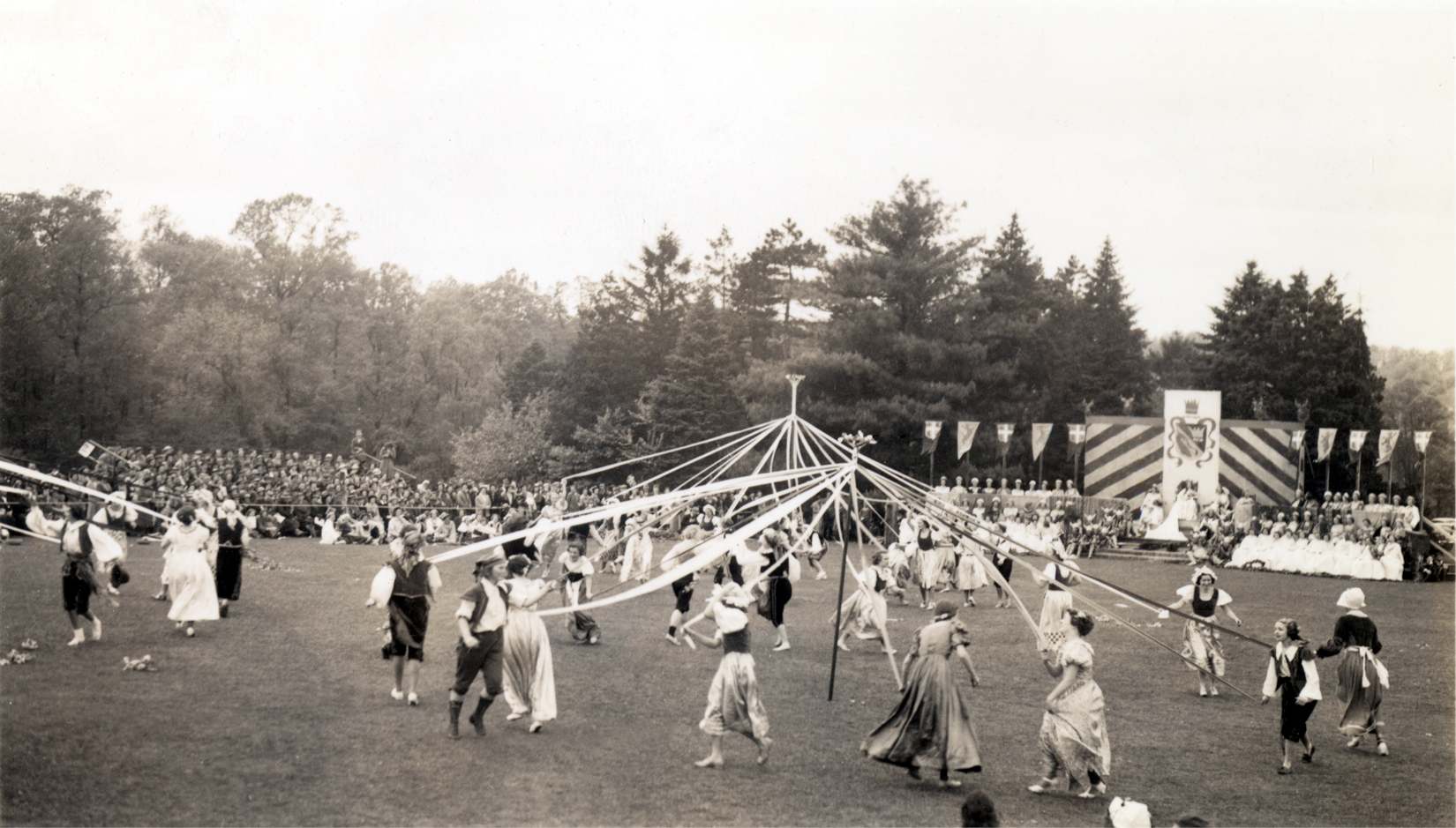 archival image of students dancing around the maypole, May Day 1937