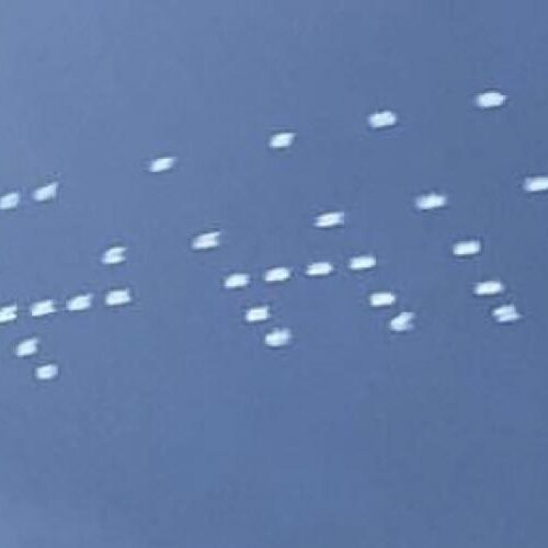 A light show in the sky where the dots spell a word