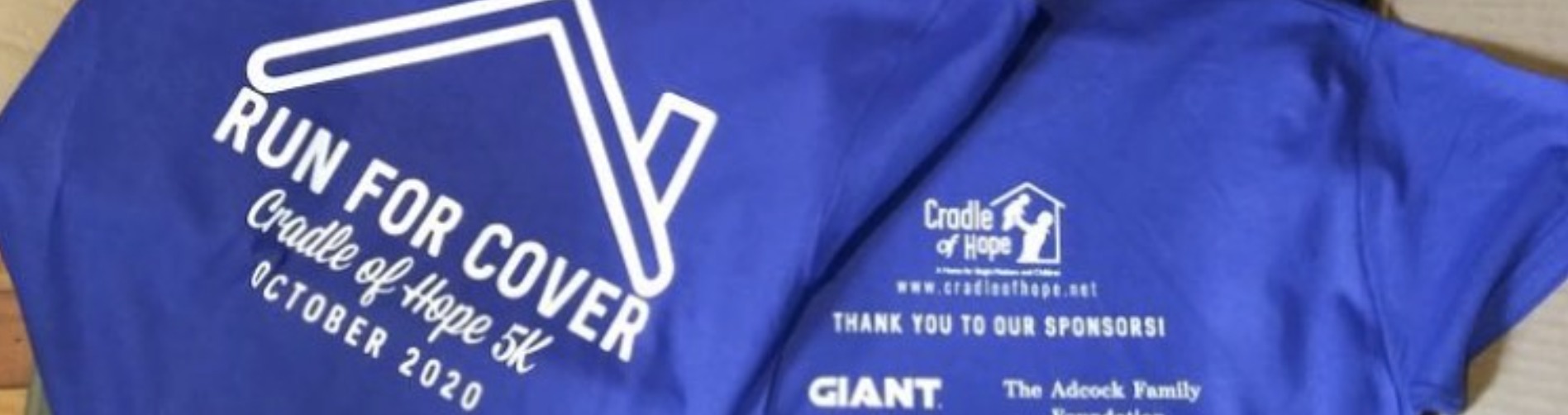 close up shot of t-shirt logo for Run For Cover Cradle of Hope 5K event