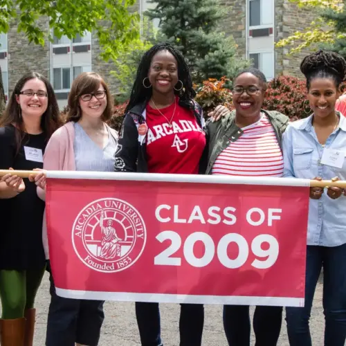 Class of 2009 students gather around a banner that reads "Class of 2009".