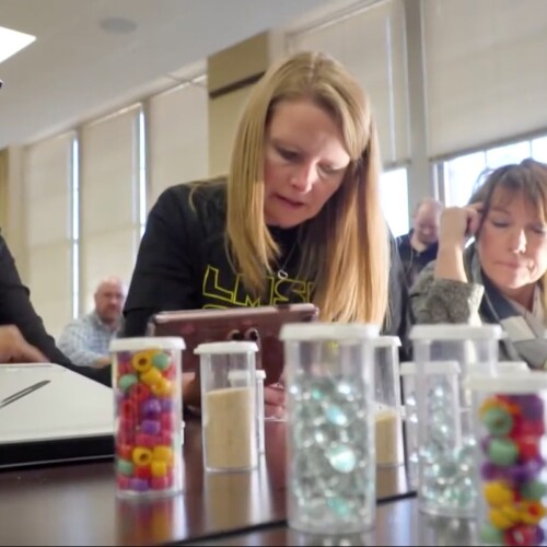 Three Arcadia STEM Education students work on a project with beads