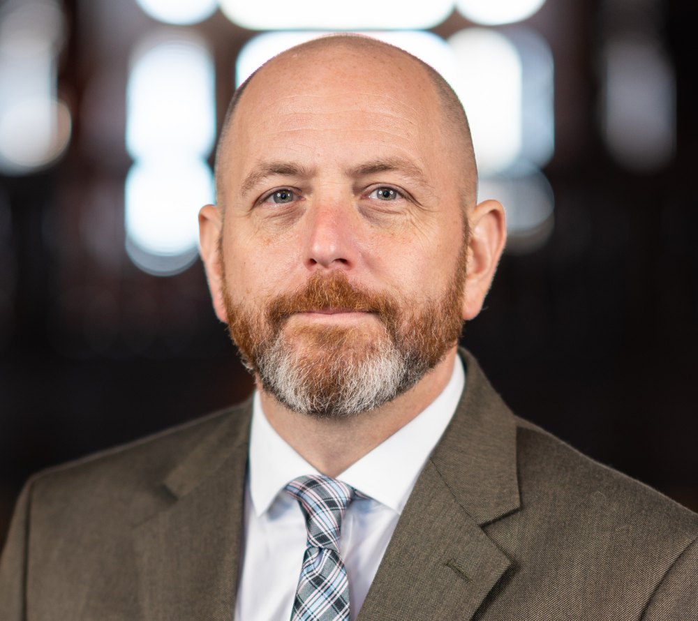 The headshot of Christopher Grosso, Director of Advancement Communications