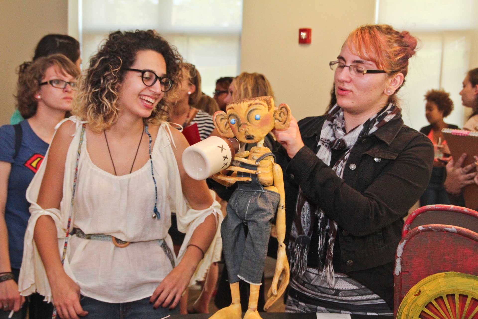 Attendees of the opening reception interacting with Isaac the Instrument of Intrique, photo: Kara Wright.