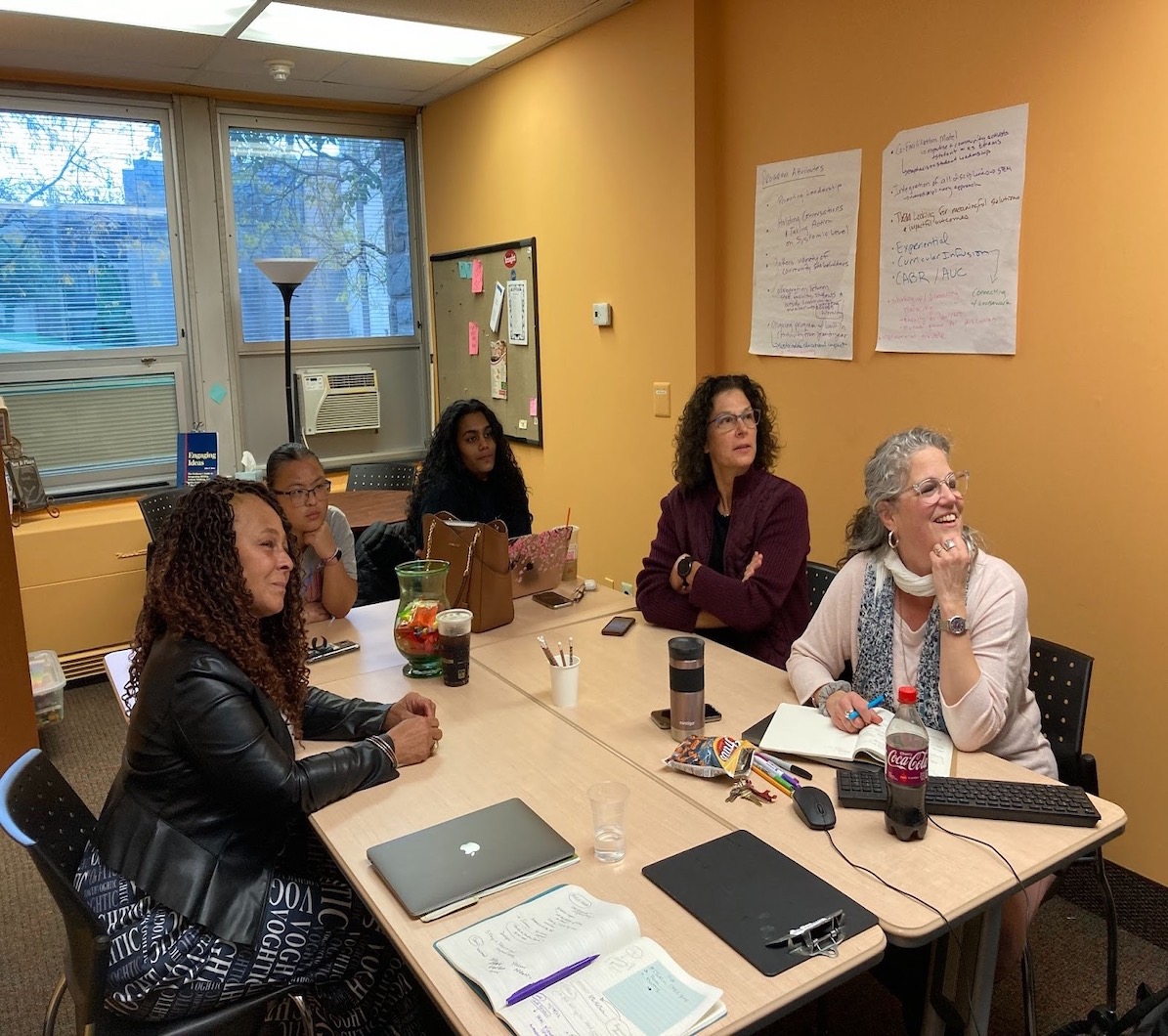 Five faculty members sitting at a table.