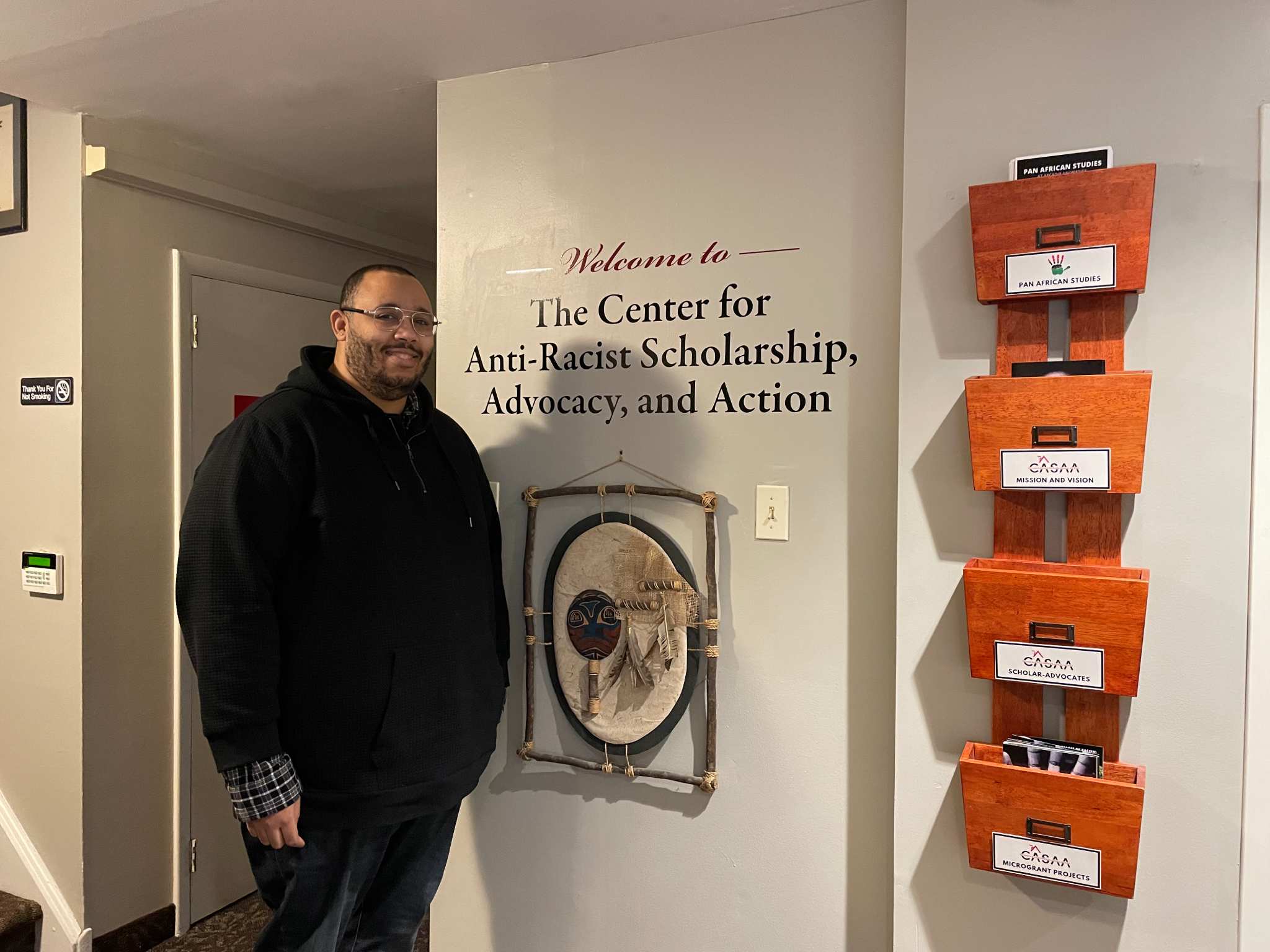 Christopher Varlack standing in the entryway of the Center for Anti-Racist Scholarship, Advocacy, and Action