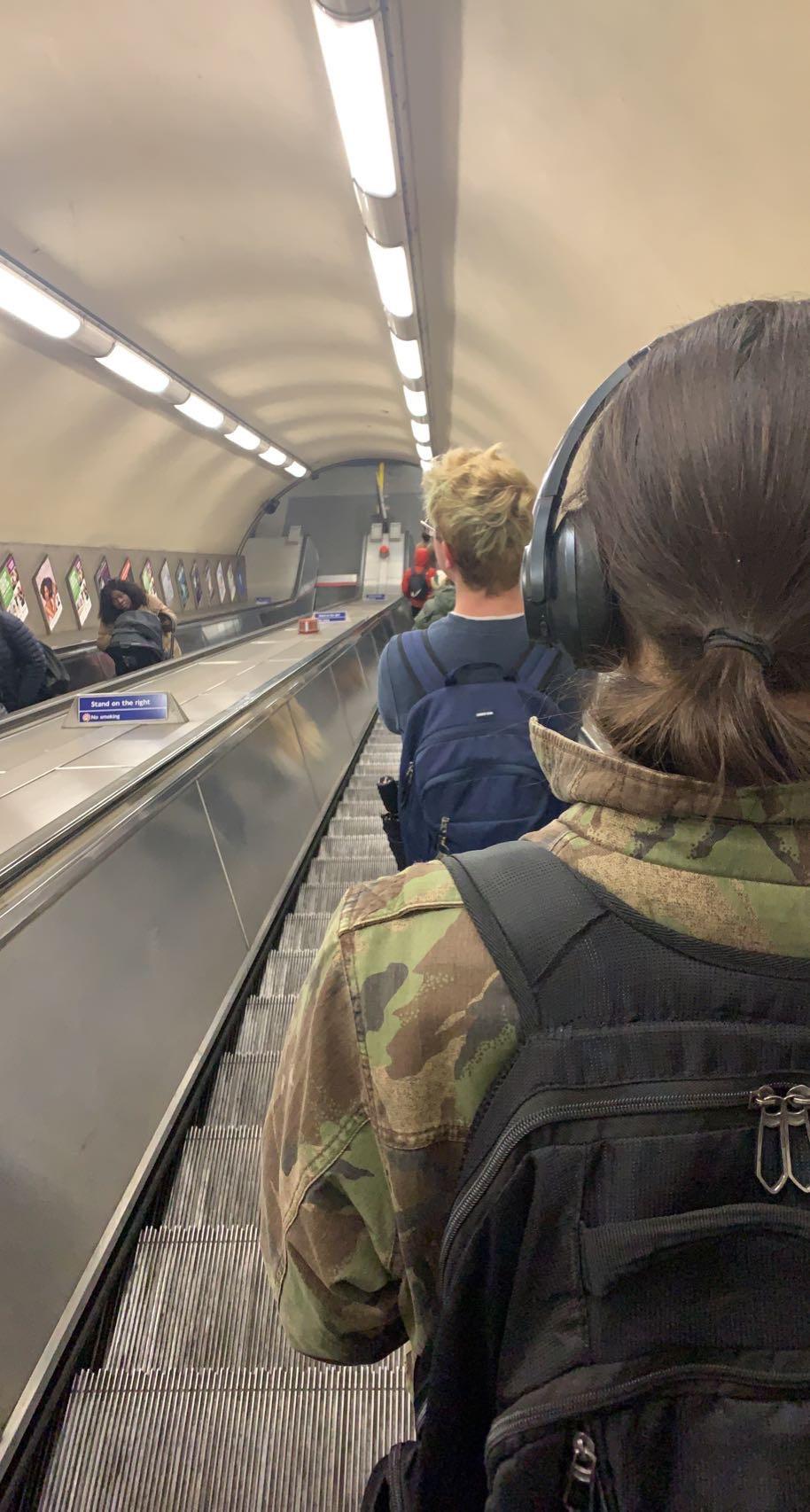 People on an escalator at an airport