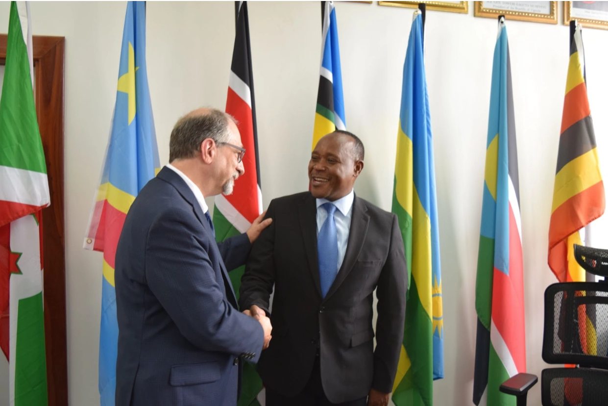 Warren Hafar shaking hands with Peter Mathuki at the relaunching of the Nyerere Centre for Peace Research