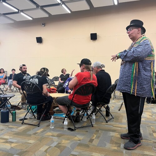 Members of the Lenape tribe in a drumming circle in the Commons Great Room