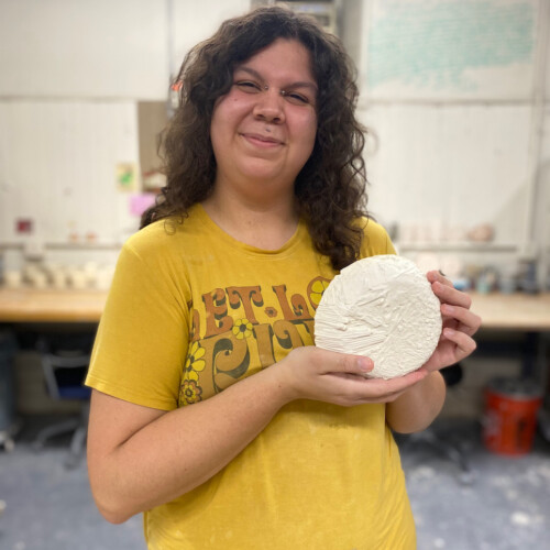 Angie Brewer holds up one of her Ceramic pieces