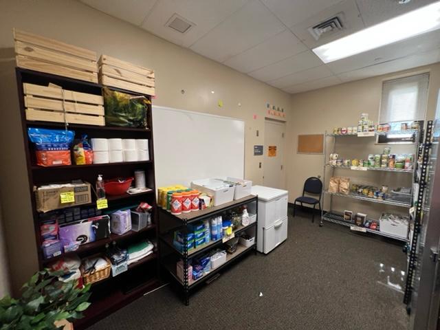 A food pantry stocked with cleaning supplies and canned foods.