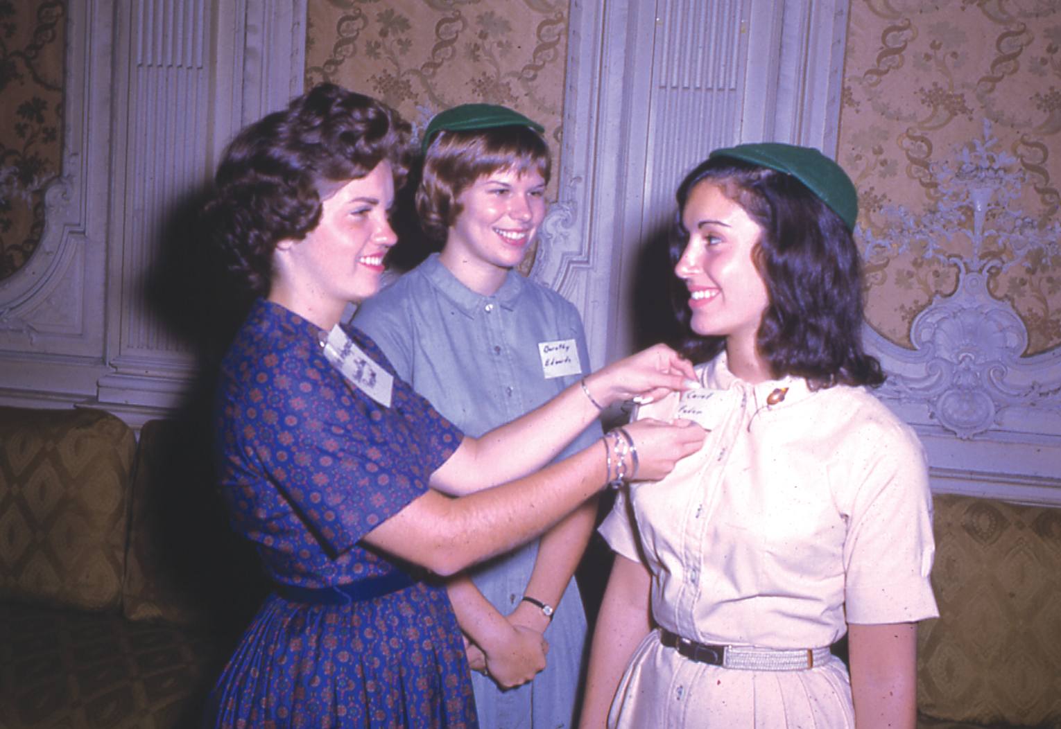 Archival image of Student Government Association President Merle Arbogast capping a freshman in the Rose Room, Grey Towers Castle, 1961.