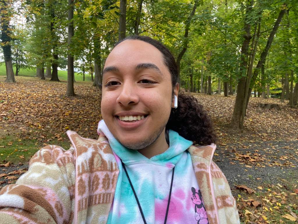 A selfie of Ethan with trees in the background.