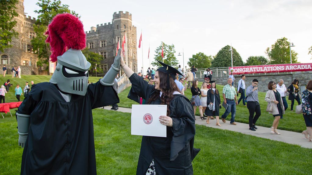 A student gives Archie a congratulatroy high-5.