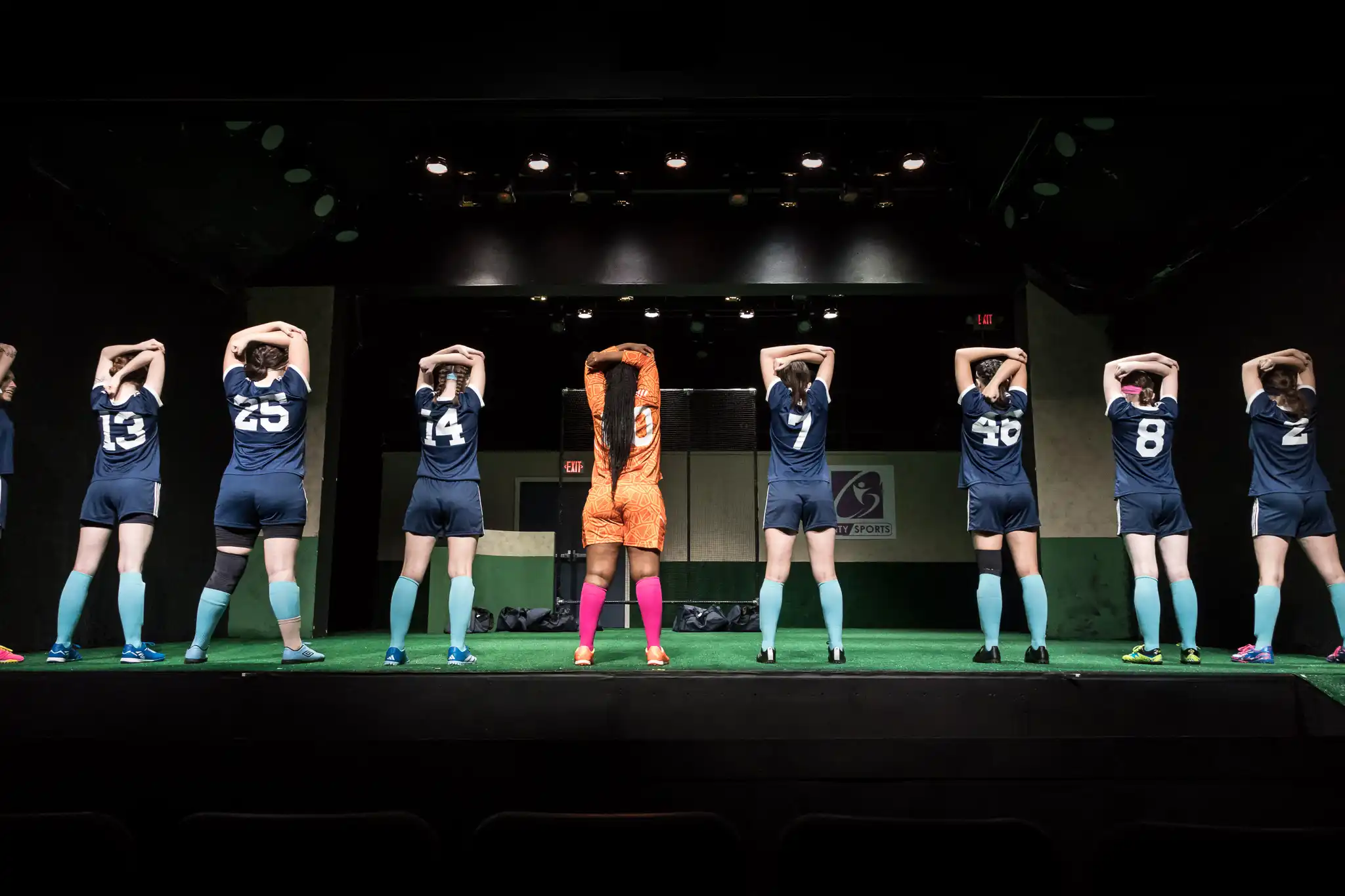 A group of soccer players warming up in the Wolves production.