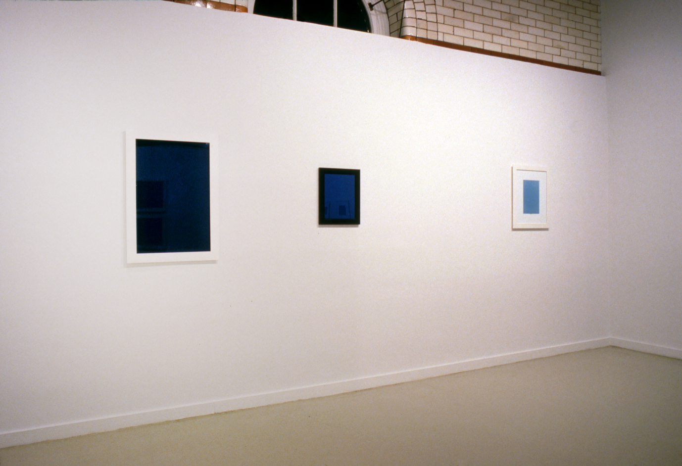 Installation view of 3 images on wall in the exhibition "Blue (NY)" by Donald Moffett.