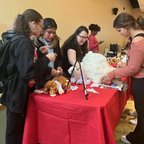 Students going to different tables at an event.