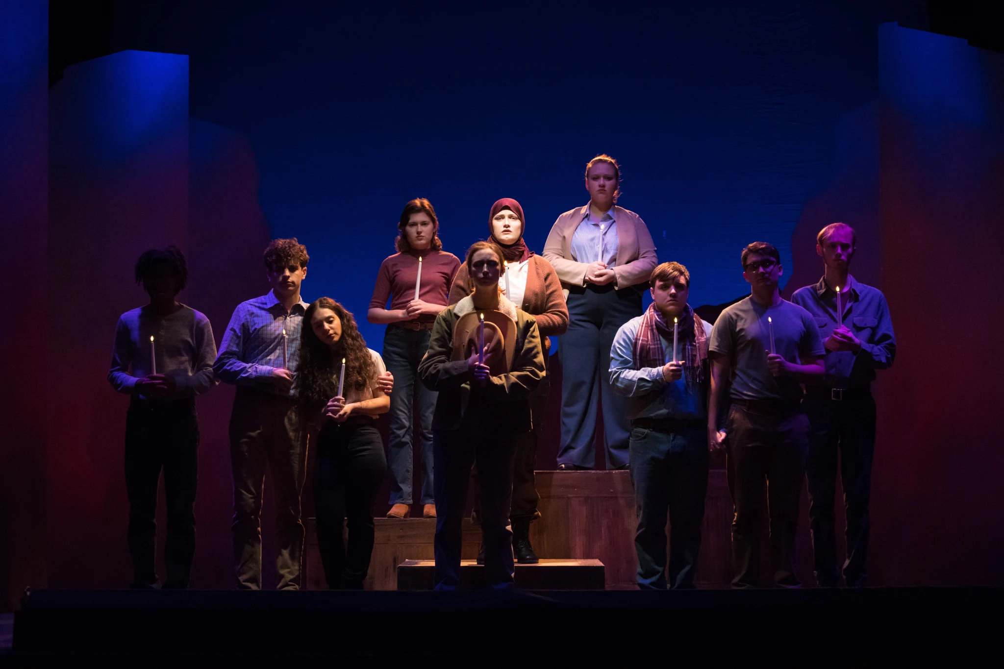 Students holding candles as a part of the Laramie Project.