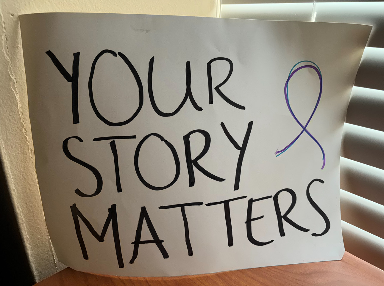 A sign reading "Your Story Matters."