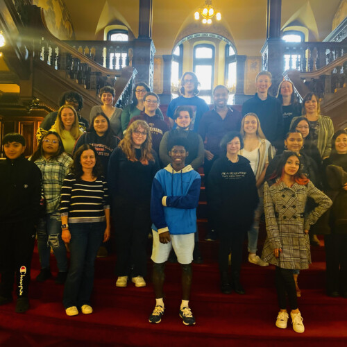 A group of students posing on the castle's grand staircase.