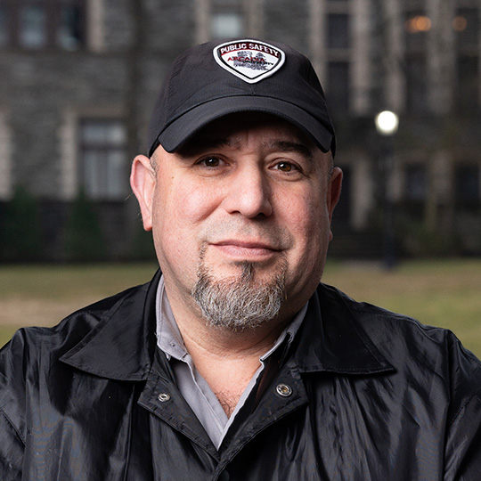 A portrait of William Ramos standing in front of Greys Castle.