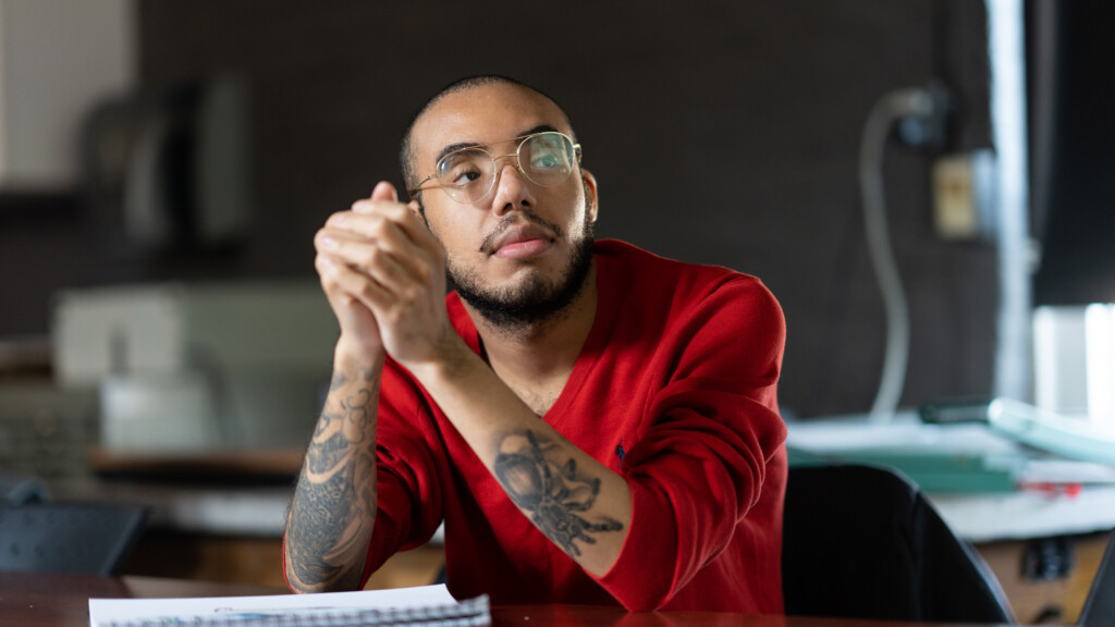 An art student listens to a lecture in an art classroom.