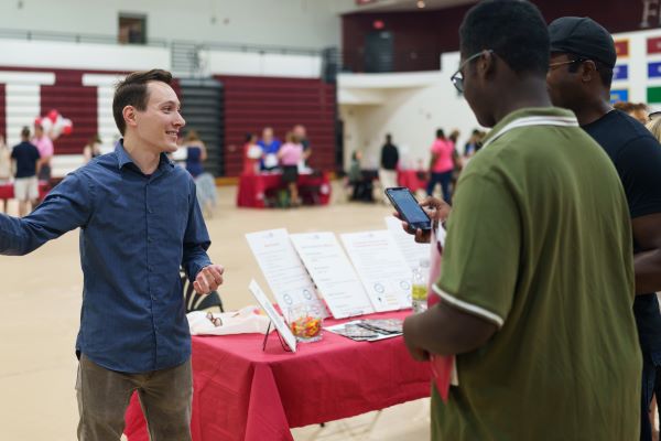 Dr. Vitaly Ford talking to students in the gym