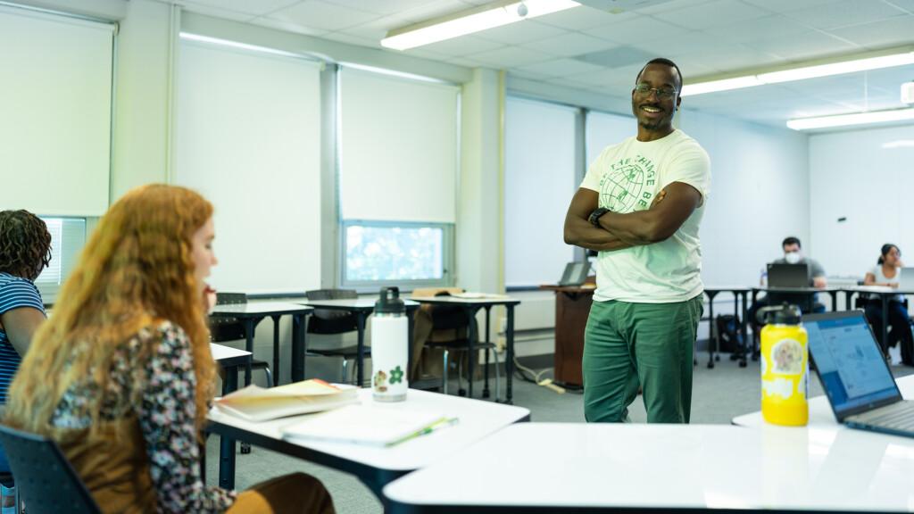 A faculty member from the School of Education talks to students in a classroom.