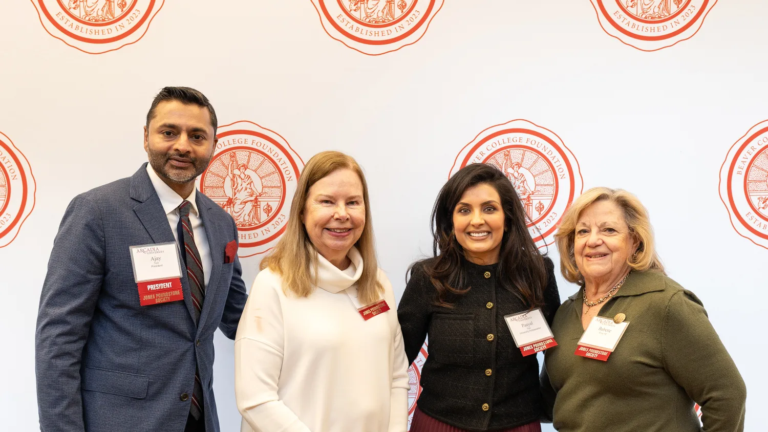 Three speakers pose with Arcadia President Nair during the Women Who Lead Forum 2024.