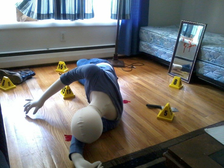 A dummy is set up in a stagged crime scene in a house.