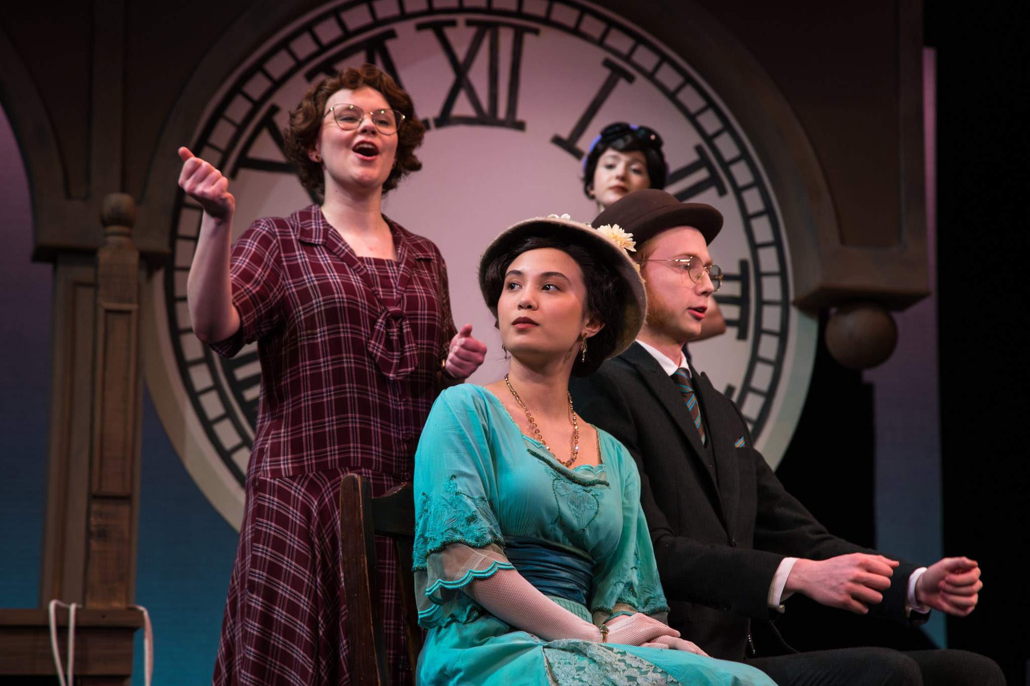 Four actor on stage doing a play inside a saloon setting