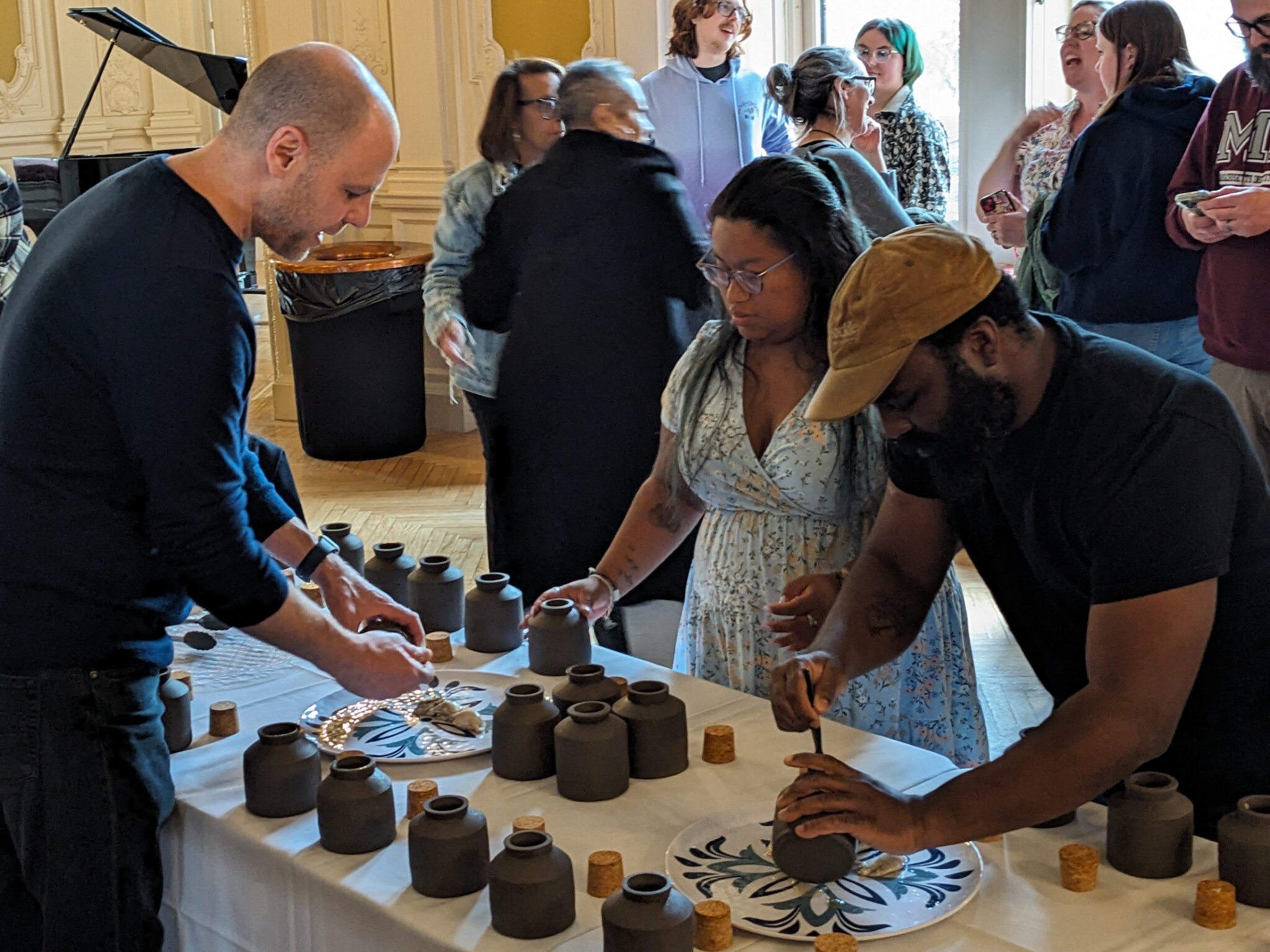 Prof. Gregg Moore and Chef Omar Tate touch up their work at the ˈȯi-stər · ve-səl pickled oyster tasting