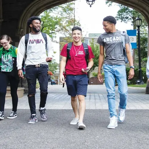 six Arcadia students of color are walking together on campus