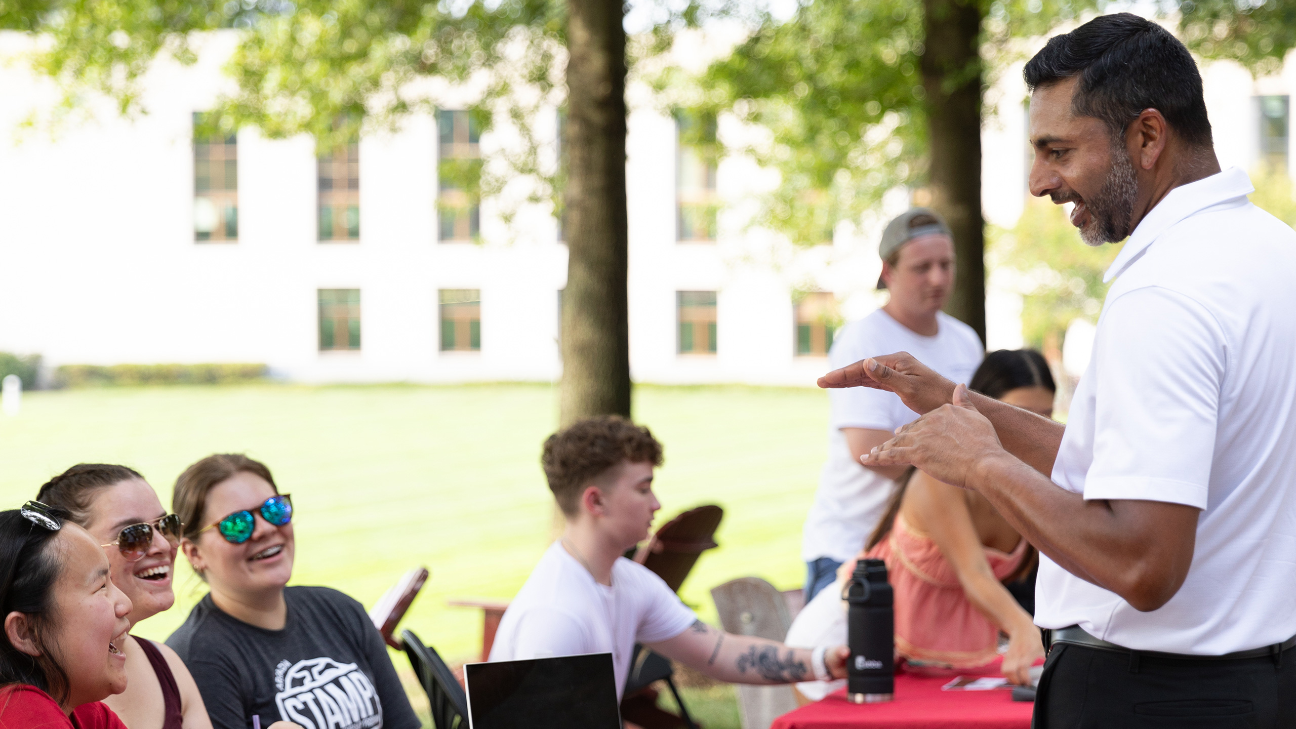 President Nair talk to students during an activity fair.