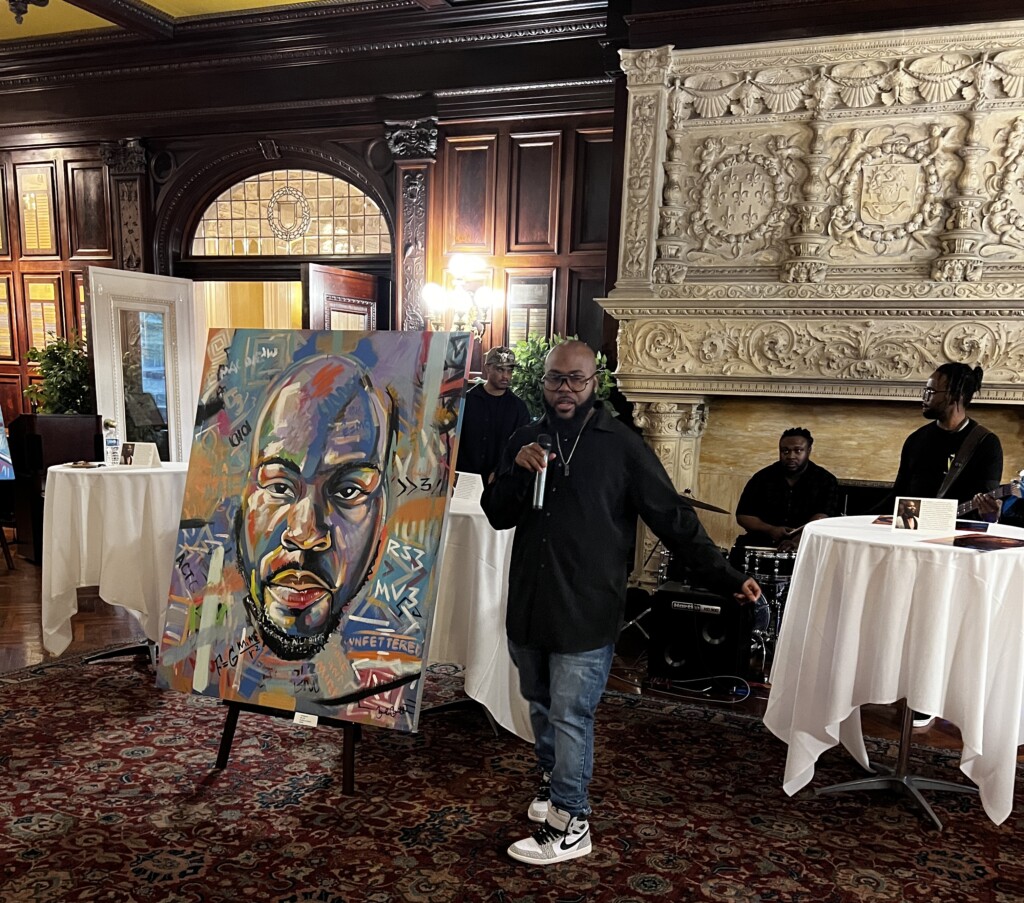 An artist doing a colorful abstract portrait of himself