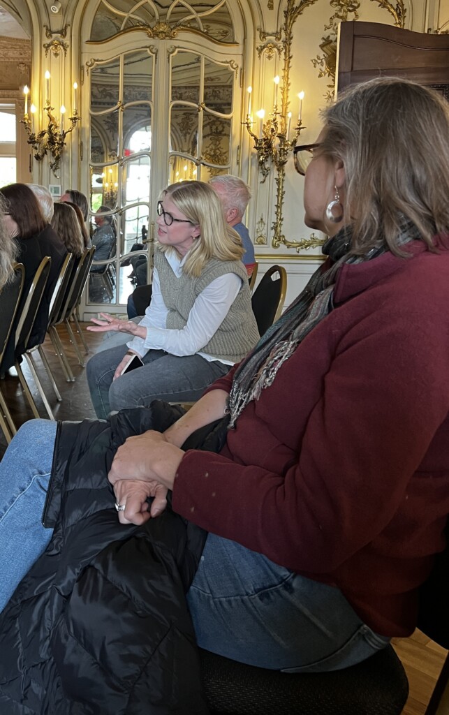 People in a conference located in the Mirror Room