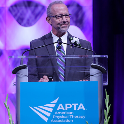 Dr. McClue at the podium delivering his speech to the APTA.