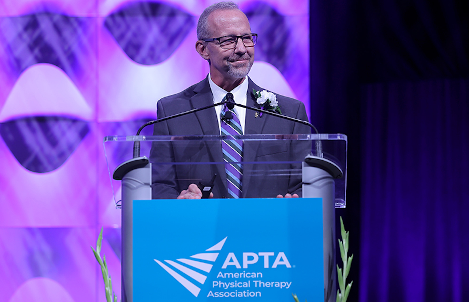 Dr. McClue at the podium delivering his speech to the APTA.