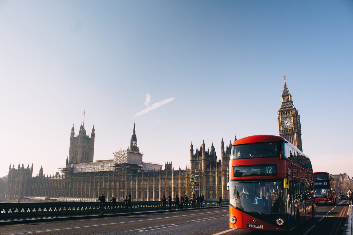 Big Ben and Parliament in London, England with red bus., blue sunny skies